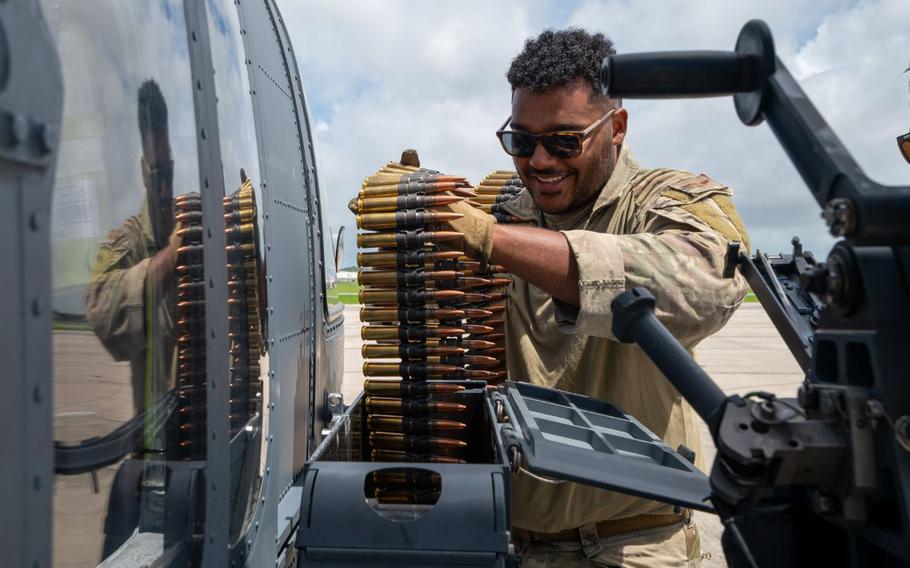 U.S. Air Force Staff Sgt. Jordan Florio, 33rd Rescue Squadron special missions aviator, loads ammunition to a GAU-21 machine gun on a HH-60W Jolly Green II assigned to the 33rd RQS before a gunnery training sortie at Kadena Air Base.